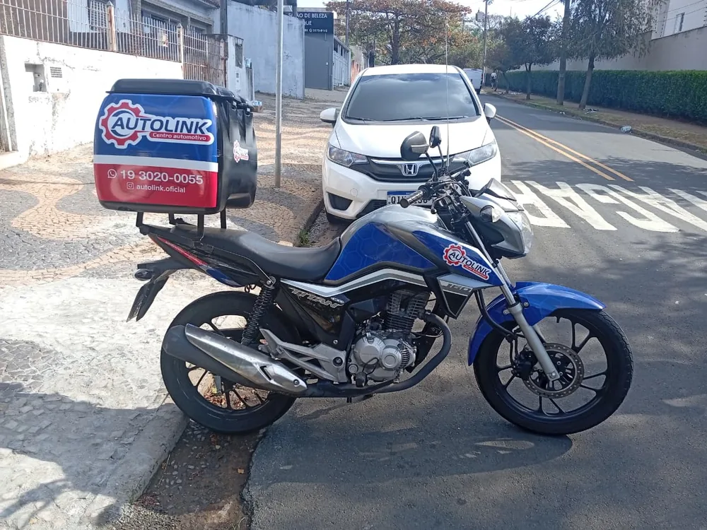 Moto com baú adesivado com a marca Autolink